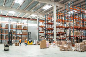 Modern warehouse interior in Bedworth with pallet racking, forklifts, and staff managing fulfilment and distribution operations.