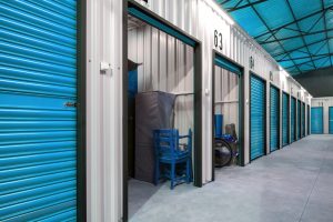 Storage lockers in self-storage site open showing stock inside them. 