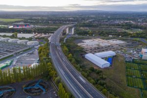 Aerial view of M60 near Manchester showing distribution routes and warehousing