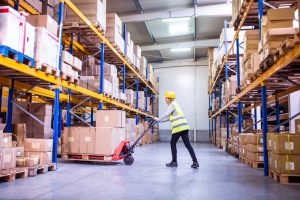 Warehouse worker moving pallet storage by forklift in Bracknell warehousing for fulfilment.