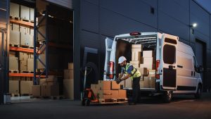 Man moving boxes out of van into the 3PL.