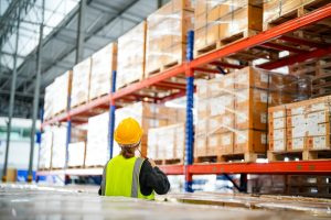 Warehouse worker looking at pallets in Newcastle under Lyme for inventory management, a 3PL service.