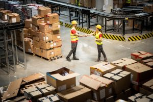 Warehouse workers doing logistics tasks around pallet storage in Chesterfield