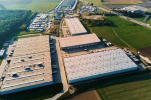 Exterior shot of 3PL where there is pallet storage & HGVs parked for fulfilment and distribution. 