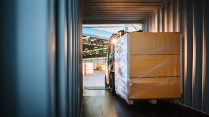 Forklift moving pallets into 3PL from HGV. 