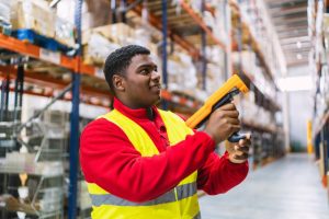 Warehouse worker scanning goods to find the correct one for order fulfilment. 