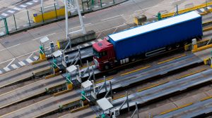HGV transporting freight out of a port at a customs and declarations checkpoint. 