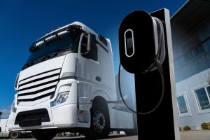 Electric HGV used for haulage at charging point for battery.