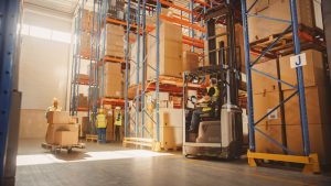 Pallet storage inside Mansfield warehousing with forklift and racking available.