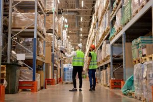 Warehouse workers looking at racked pallet storage inside 3PL in Herefordshire.