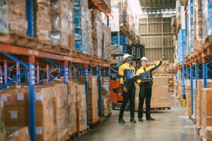 Warehouse workers looking at pallet storage inside Ripon 3PL for fulfilment deliveries.
