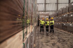 Logistics workers looking at pallets for fulfilment and freight forwarding.
