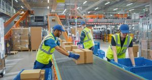 Warehouse workers packaging goods for fulfilment in the UK.