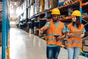 3PL workers walking through pallet storage using warehouse integrations to find stock for order fulfilment.