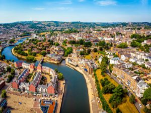 Aerial view of Exeter with warehousing and fulfilmentb centre immediately available and view of the River Exe running through.