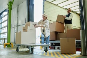 Warehouse workers moving boxes into a truck for order fulfilment. 