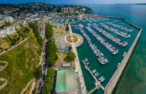 Aerial shot of Torquay port and coastal town with warehousing and 3PLs in this distance.