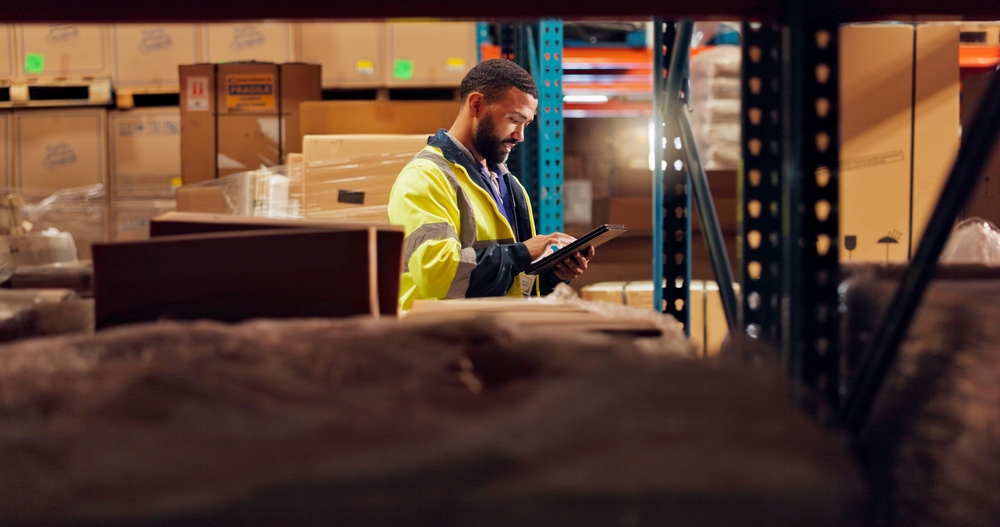 Warehousing in Altrincham with warehouse worker looking for goods for order fulfilment.