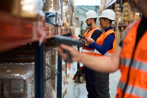 Warehouse workers in US fulfillment centre scanning goods for pick and pack.
