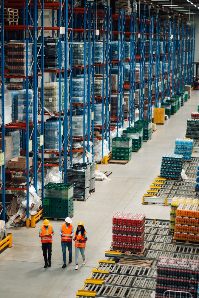 Large racked pallet storage aisle in Moseley with warehouse workers walking past.