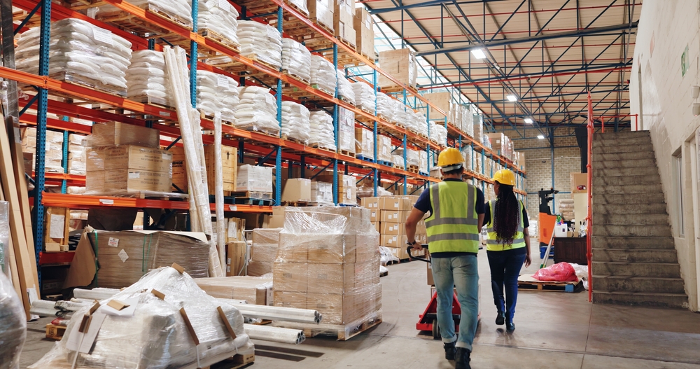 Warehousing in Ohio with racked pallet storage and warehouse workers moving goods. 
