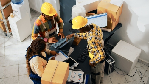 Warehouse workers labelling and packaging order for fulfilment. 