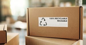 Delivery package which says 100% recyclable and reusable sitting in a warehouse.